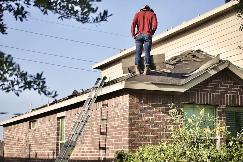 Professional roofer working on a residential roof in Worcester
